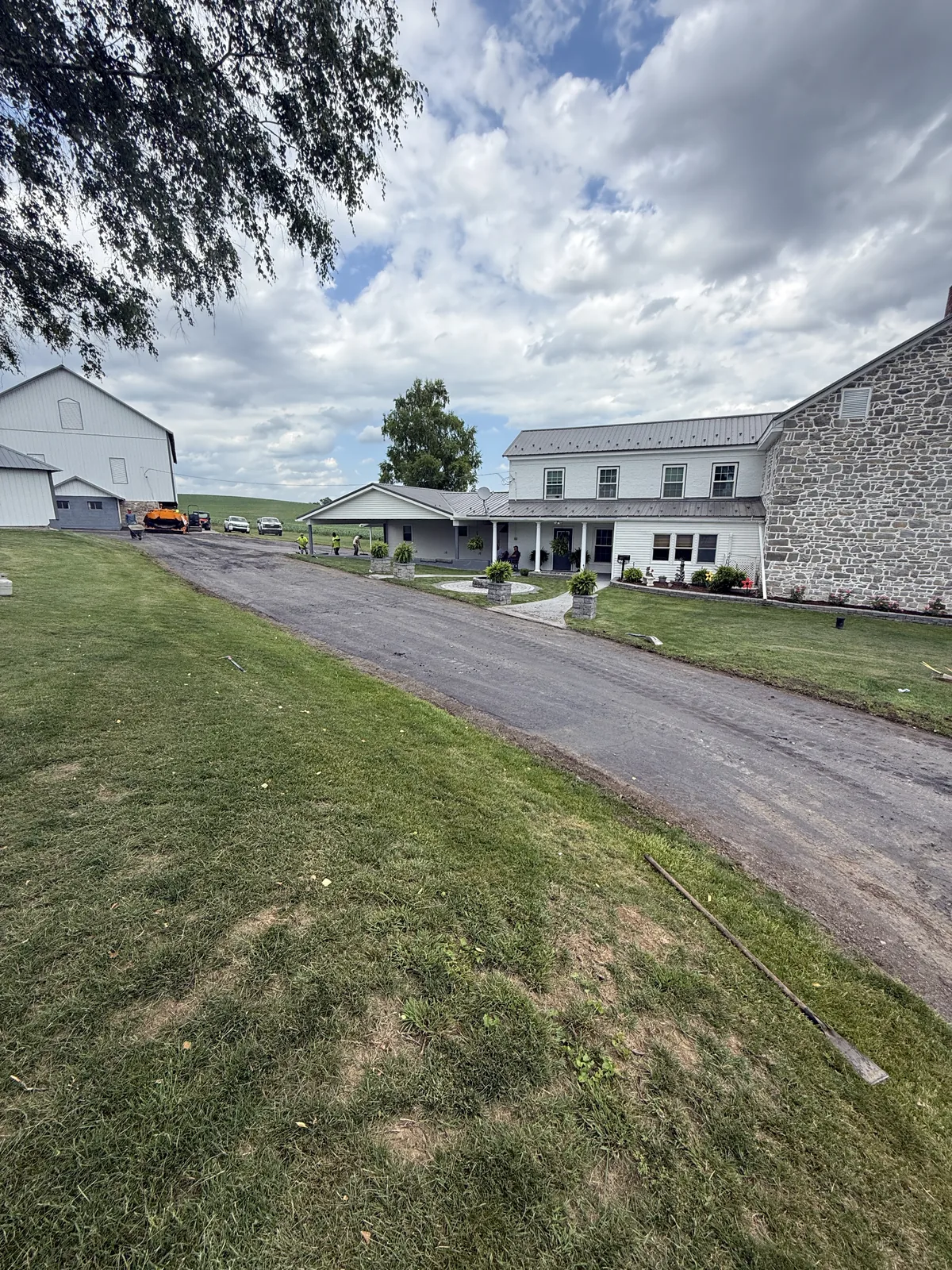Residential driveway beside a farmhouse before surface work