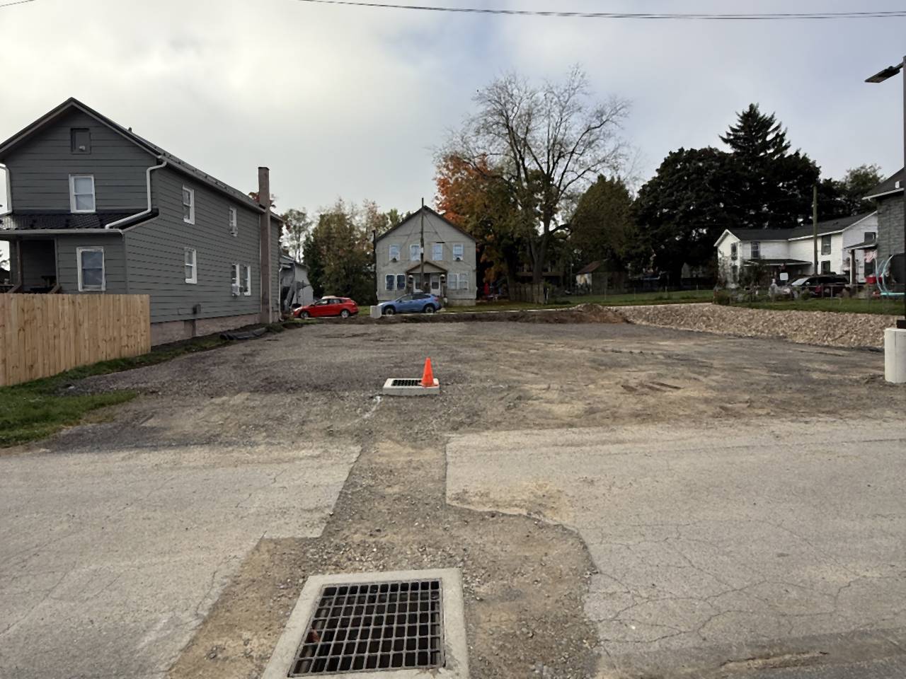 Storm drain grate set in a prepared stone base before paving.